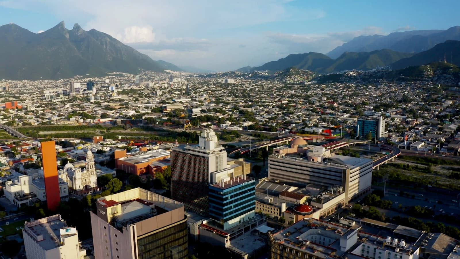 Aerial view of the Monterrey, Nuevo Leon skyline with the Cerro de la Silla mountain rising behind the city, illustrating one of Mexico's leading manufacturing regions