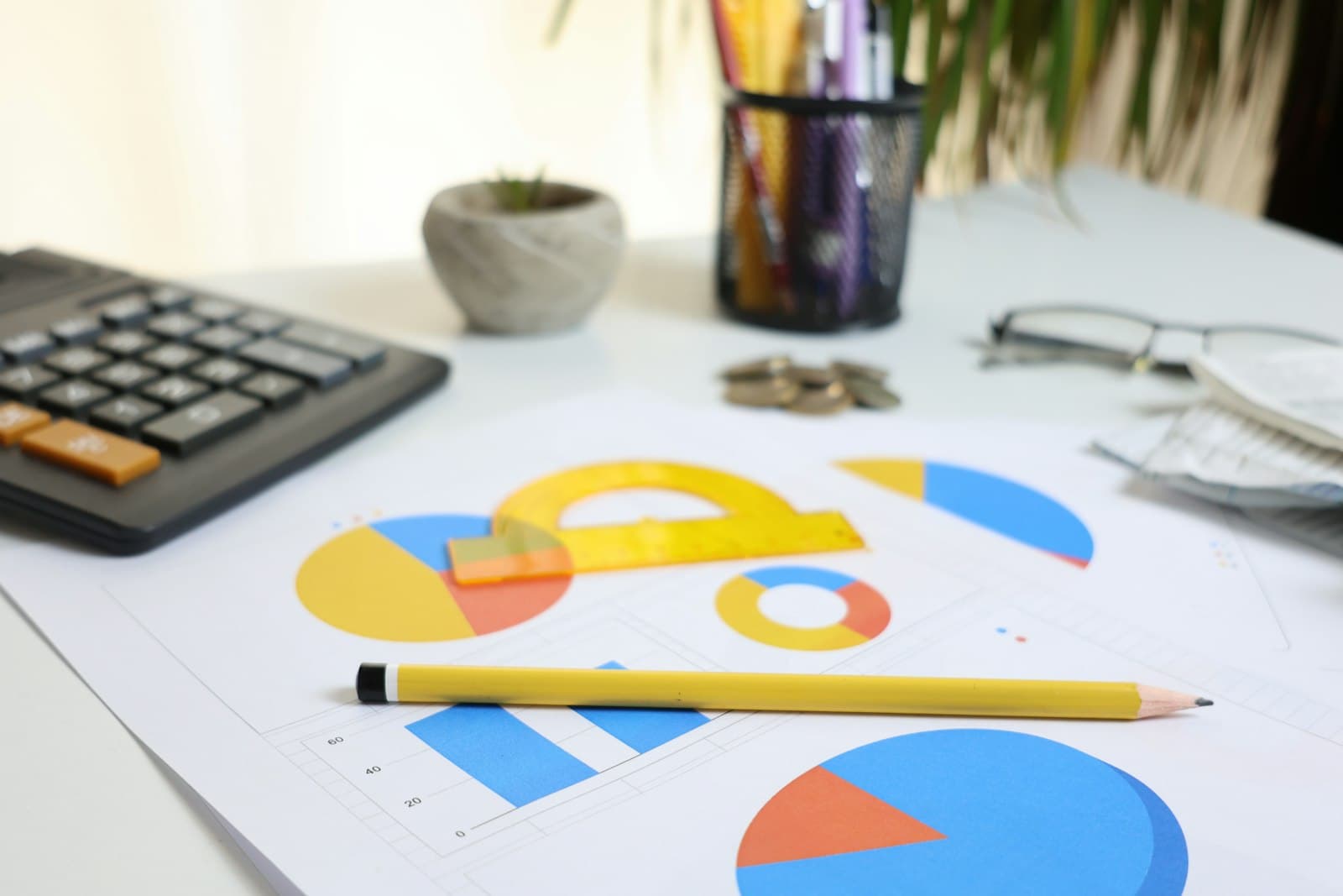 Calculator, pencil and printed cost charts on a desk, the working tools for comparing shelter program quotes line by line